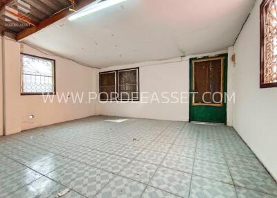 Spacious empty room with tiled floor and multiple windows