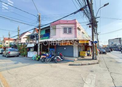 Street view of a storefront building on a corner