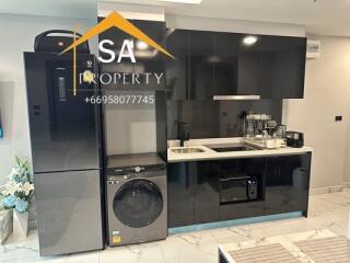 Modern kitchen with sleek black appliances and cabinetry