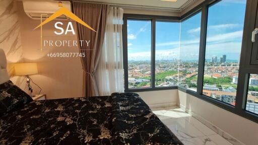 Bedroom with a large window offering a city view