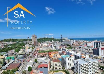 Panoramic view of the city landscape with various buildings and the ocean in the background