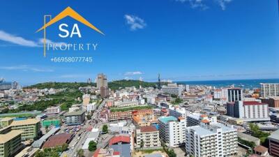 Panoramic view of the city landscape with various buildings and the ocean in the background