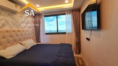 Modern bedroom with a tufted headboard and a large window with city view