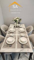 Modern dining table set with tableware and flower arrangement