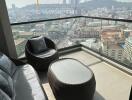 High-rise apartment balcony with outdoor furniture and city view