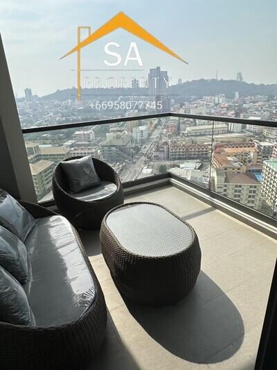 High-rise apartment balcony with outdoor furniture and city view