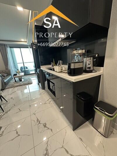 Sleek modern kitchen with black cabinetry and white countertops