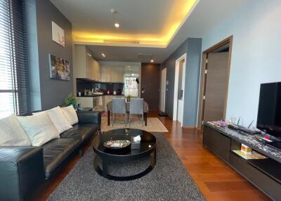 Modern living room with kitchen in the background