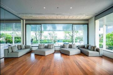 Modern living room with large windows and hardwood floors