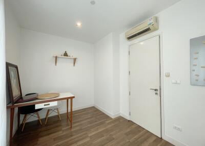 Well-lit home office with desk and wall-mounted shelf