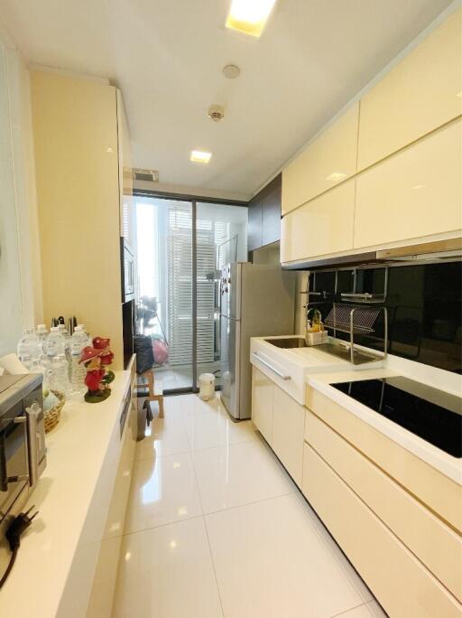 Bright modern kitchen with white cabinets and appliances