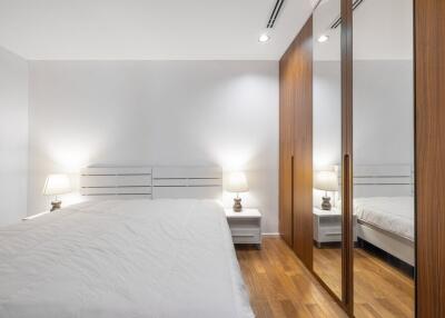 Bedroom with white walls and wooden floor