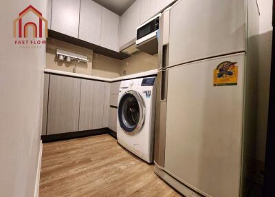 Modern kitchen with white appliances and wooden flooring