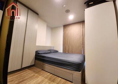 Modern bedroom with built-in storage and wooden flooring