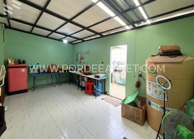 Spacious and well-lit utility room with storage and appliances