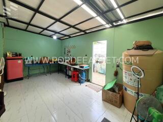 Spacious and well-lit utility room with storage and appliances