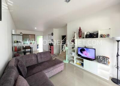 Spacious and modern living room with sectional sofa and entertainment center