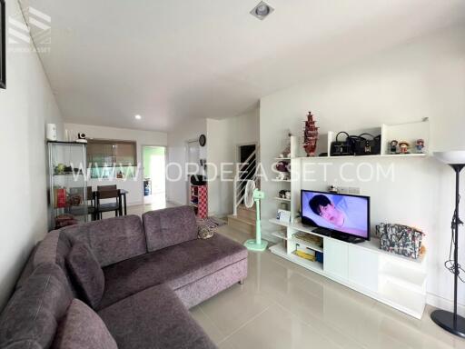 Spacious and modern living room with sectional sofa and entertainment center