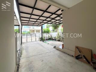 Covered carport with view of the front yard