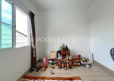 Room with religious shrine and window