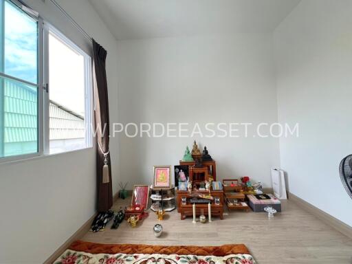 Room with religious shrine and window