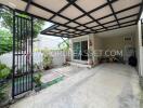 Covered outdoor area with plants and a storage space