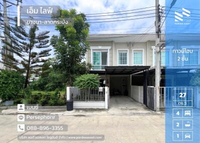 Front view of a two-story townhouse with a driveway and small garden