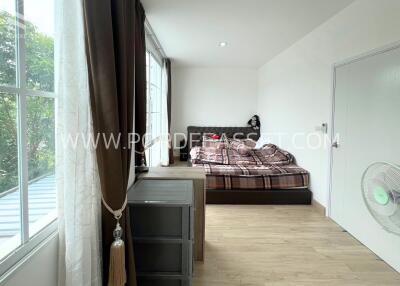 Bright bedroom with large windows and natural light