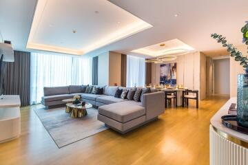 Modern living room with a sectional sofa and a dining area