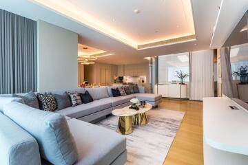 Modern living room with gray sectional sofa and open dining area