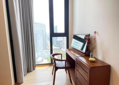 Cozy bedroom with a view of the city skyline.