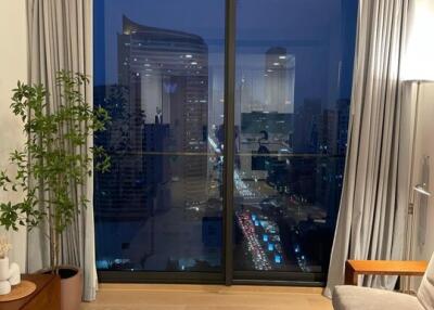 Modern living room with large window overlooking city skyline