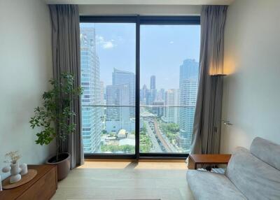 Living room with a large window and city view