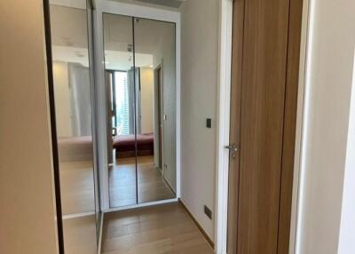 Modern interior hallway with wooden door and mirrored closet