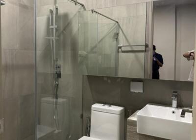 Modern bathroom with glass shower and large mirror