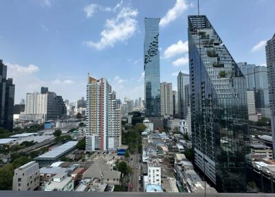 Cityscape with tall modern buildings under a clear blue sky