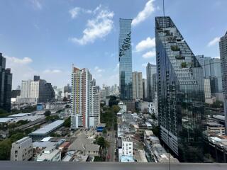 Cityscape with tall modern buildings under a clear blue sky