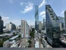 Cityscape with tall modern buildings under a clear blue sky