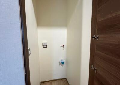 Small utility space with plumbing fixture