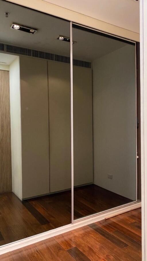 Bedroom with mirrored sliding door closet