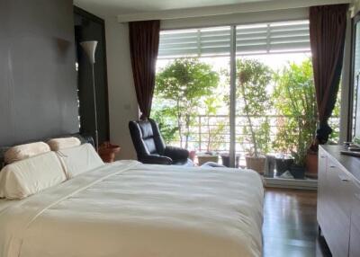 Spacious bedroom with balcony access and natural light