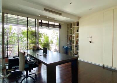 Modern home office with large window and built-in shelves