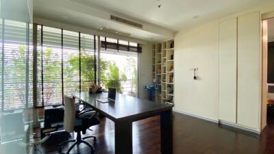 Modern home office with large window and built-in shelves