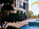 Outdoor pool area with lounge chairs and landscaped surroundings