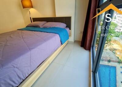 Bedroom with large window and pool view