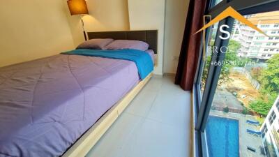 Bedroom with large window and pool view