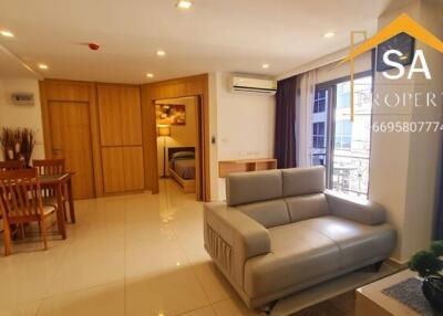 Spacious living room with dining area and view into the bedroom