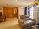 Spacious living room with dining area and view into the bedroom