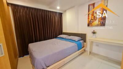 Bedroom with a bed, side table, painting, and brown curtains