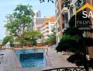 View of a pool area between two apartment buildings